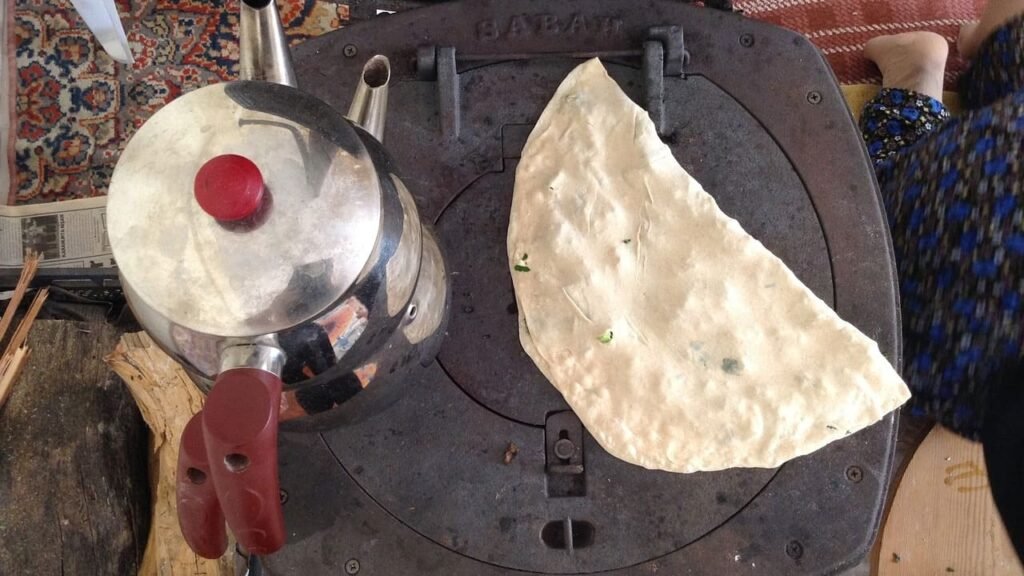 Gözleme on grilled with tea aside with tea kettle