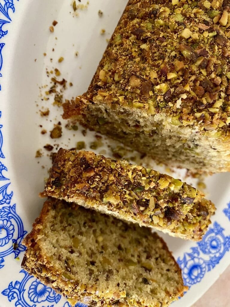 A loaf of pistachio bread sliced into slices