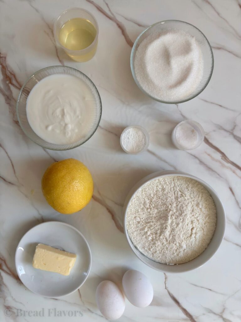 lemon bread batter includes lemon, flour, butter, oil, yogurt, eggs, and other ingredients.