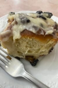 a close up of Chelsea bun with cheese icing