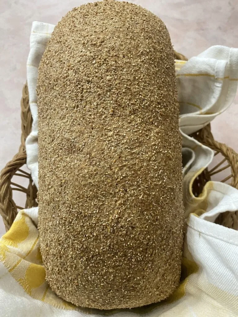 A loaf of bran bread in a bread basket