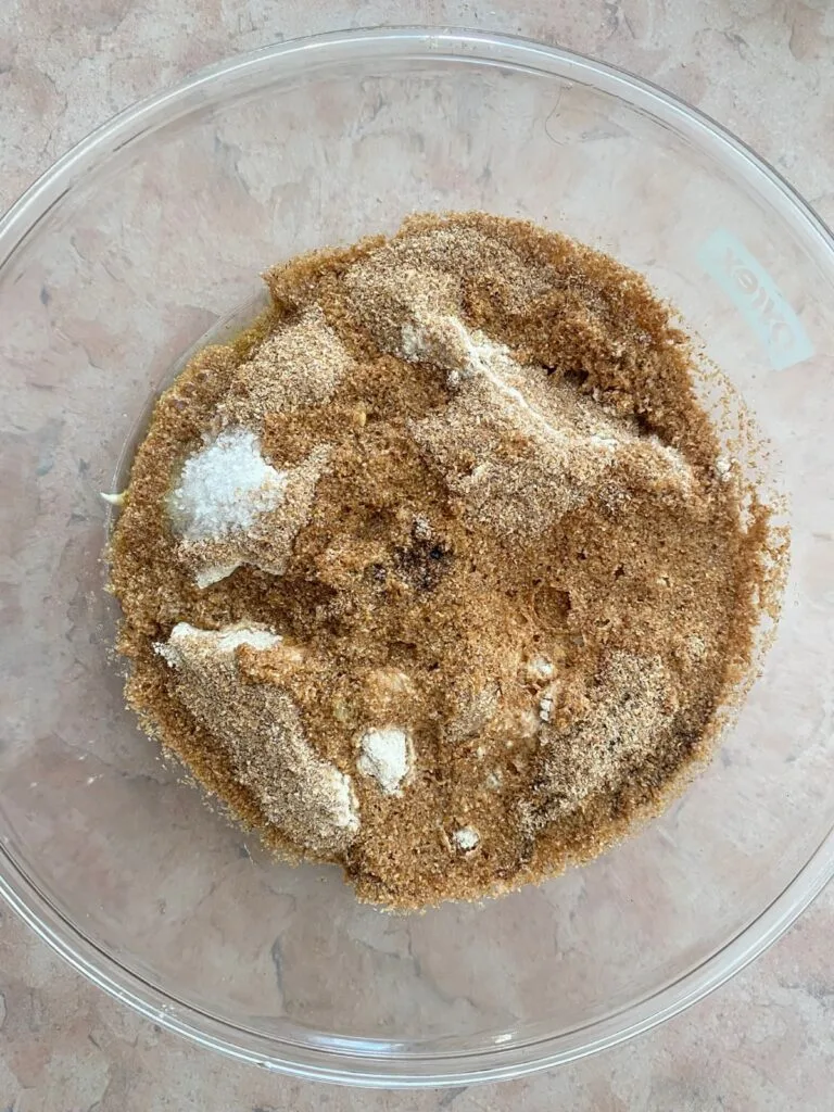 The sponge covered with all the wet and dry ingredients in a large bowl.