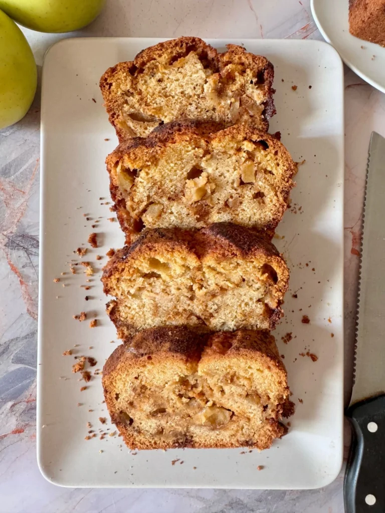 4 slices of apple cinnamon quick bread on white platter 