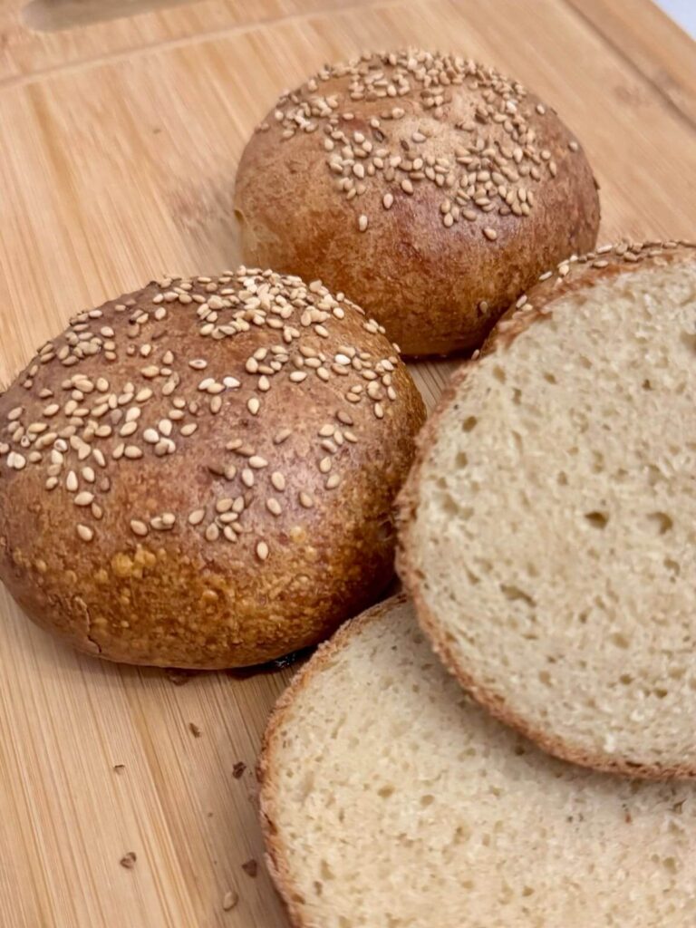 gluten free hamburger buns on wooden board.