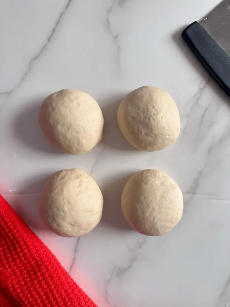the hoagie rolls dough divided into four equal pieces