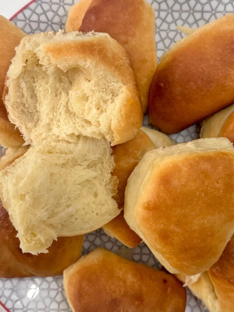 A big batch of Parker House rolls on a plate.