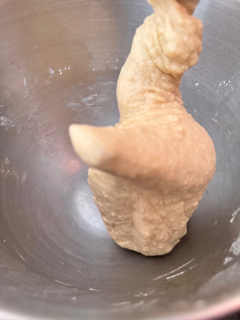 Parker House roll dough sticks to the dough hook after 1 phase of mixing.