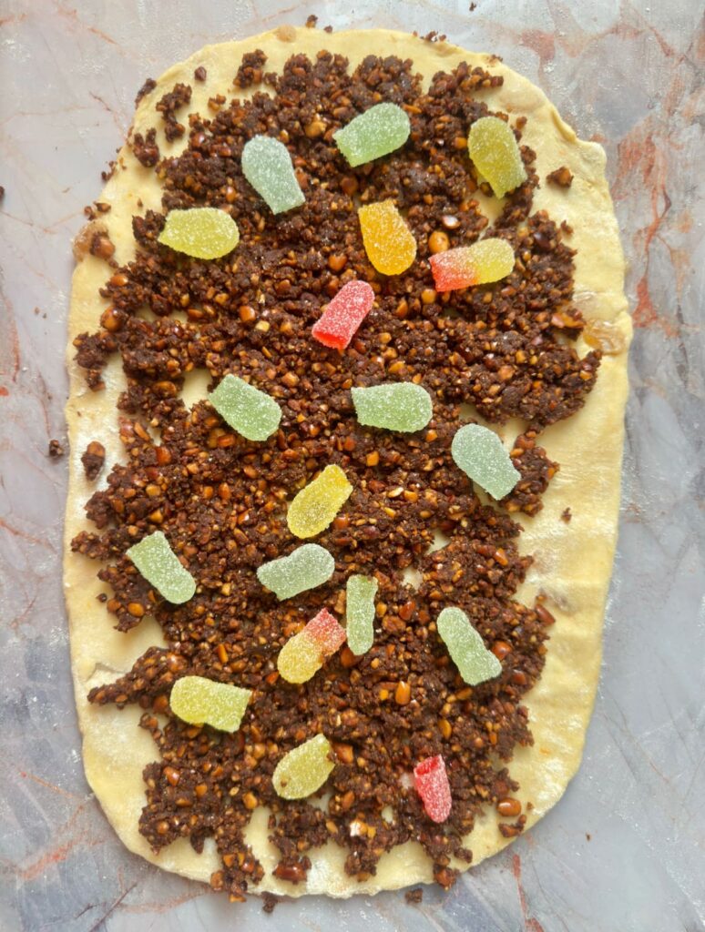 Cozonac dough spread with walnut cocoa filling and garnished with Turkish delight