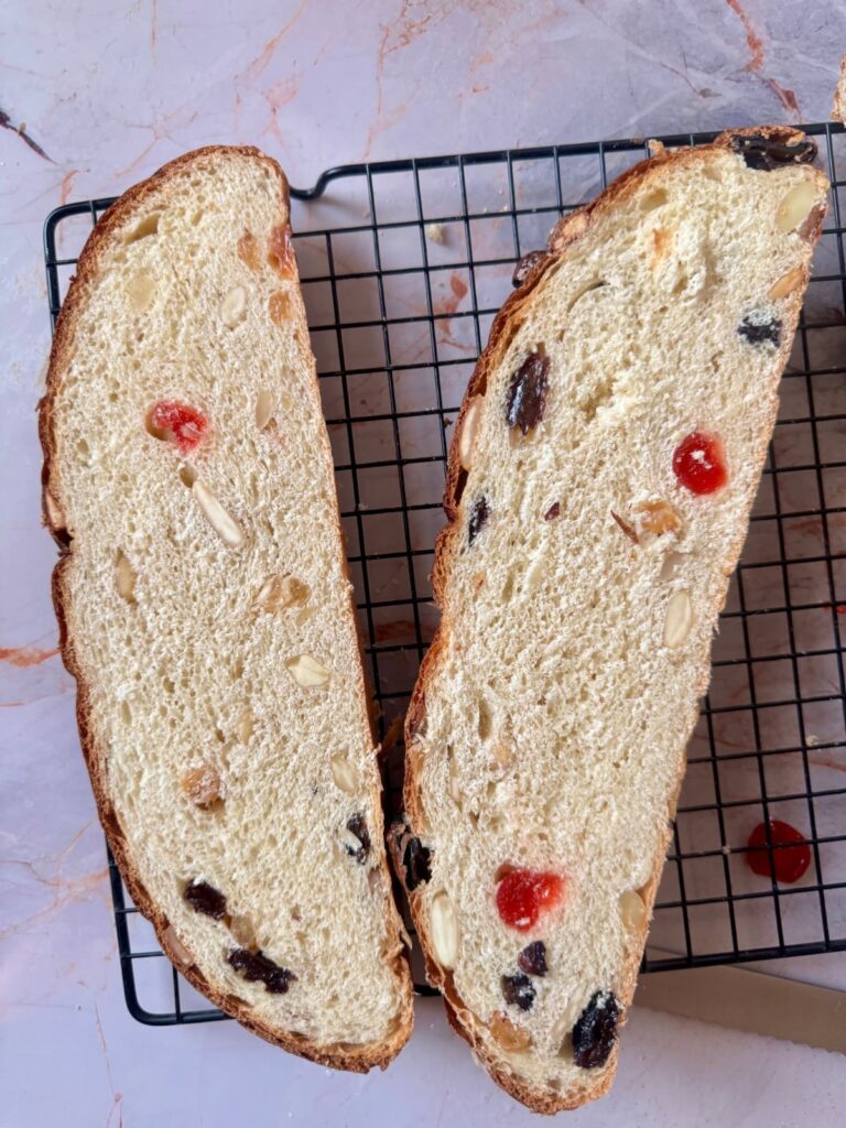 A close-up shows the crumbs from two slices of julekake.