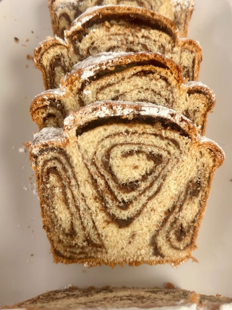 Stacked slices of Povitica bread showing walnut swirls.