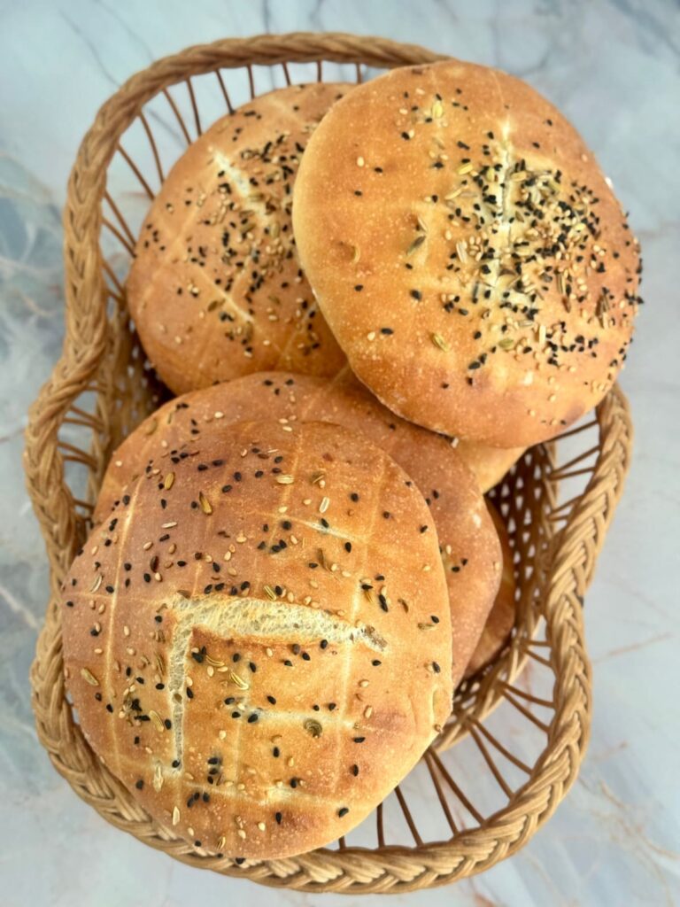 Close up of Lepinja flatbread arranged in a bread basket.